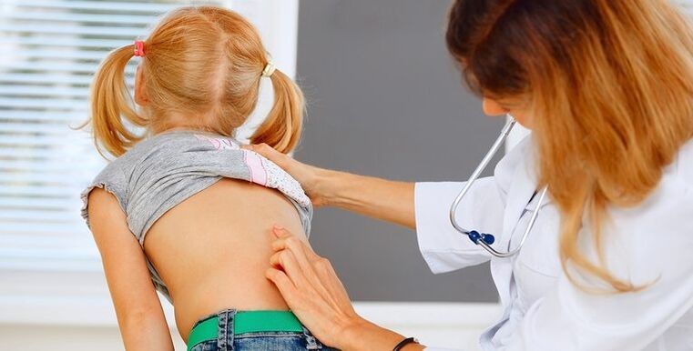 dọkịta na-enyocha azụ nwatakịrị maka mgbu azụ azụ